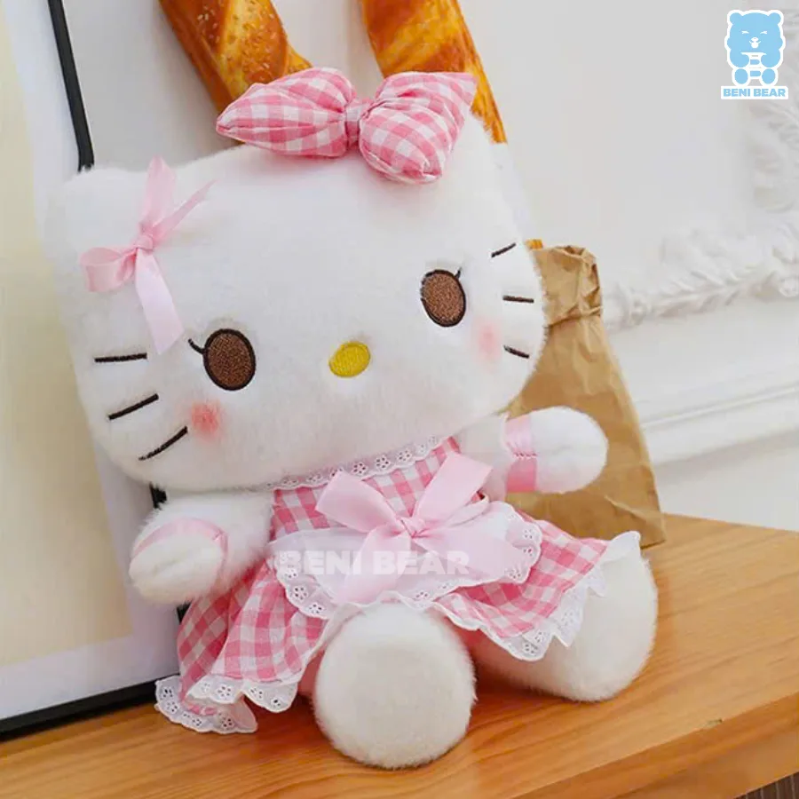 Gấu bông Hello Kitty mặc váy kẻ caro hồng pastel, đeo nơ bản to cực dễ thương