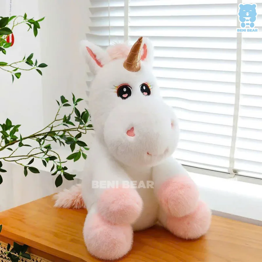Gấu bông kỳ lân chibi mắt to tròn, chân hồng pastel ngồi cạnh cửa sổ, lông trắng mịn như mây